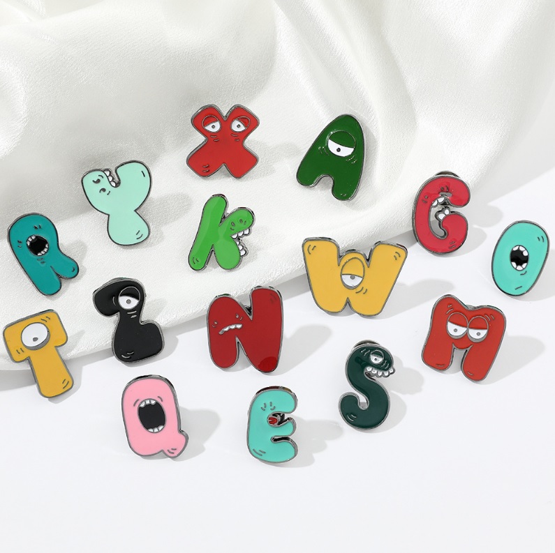 A collection of custom letter enamel pins inspired by popular game characters.