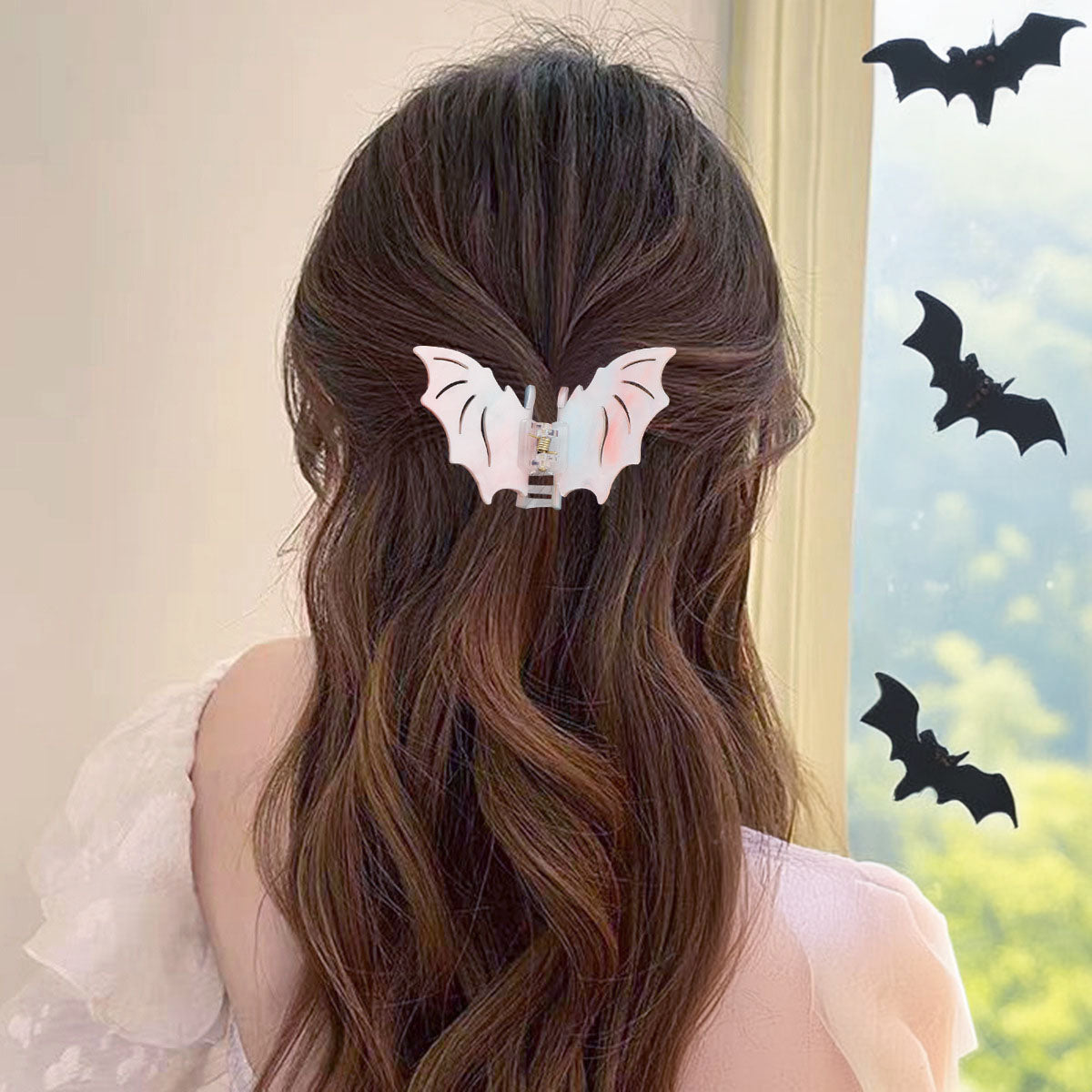 A woman showcasing the bat hair clip in her hair.