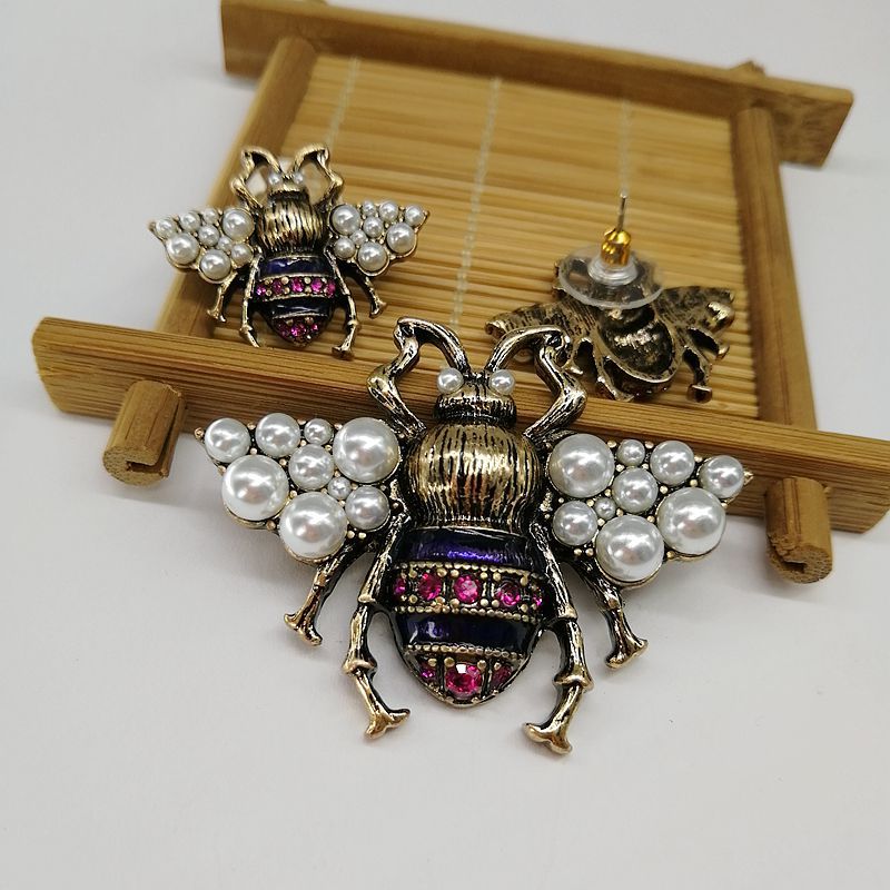 The bee brooch styled with matching earrings from the Galaxy Memory Collection