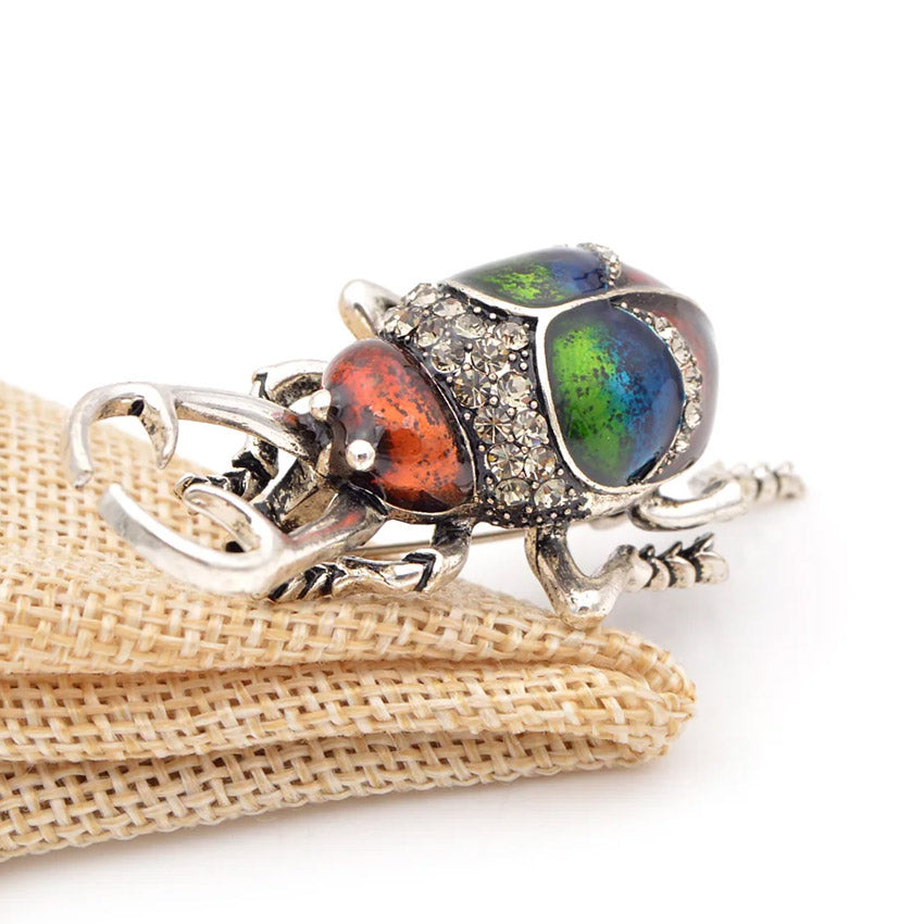 Detailed view of the beetle brooch with colorful stones