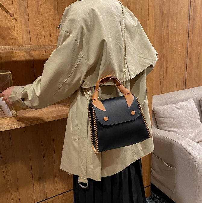 Black version of the PU leather handbag with brown accents