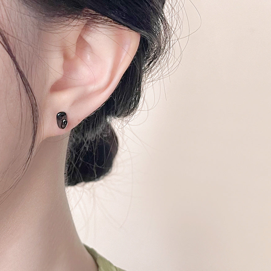 Model wearing the simple black stud earring