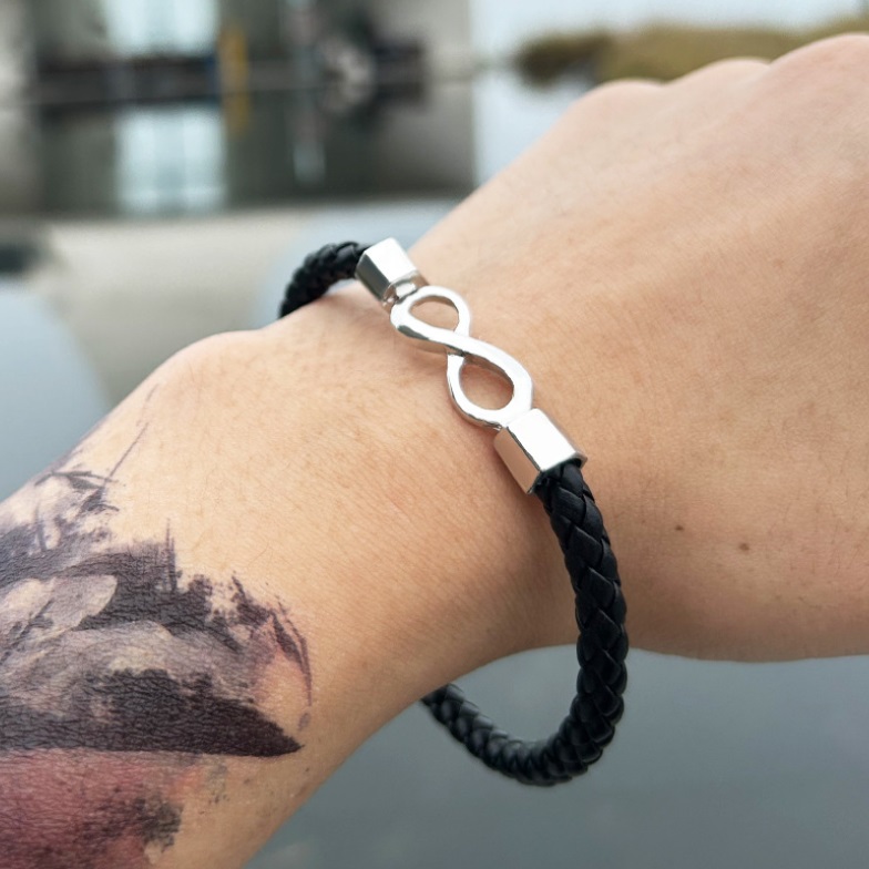 A man wearing the infinity braided PU leather bracelet