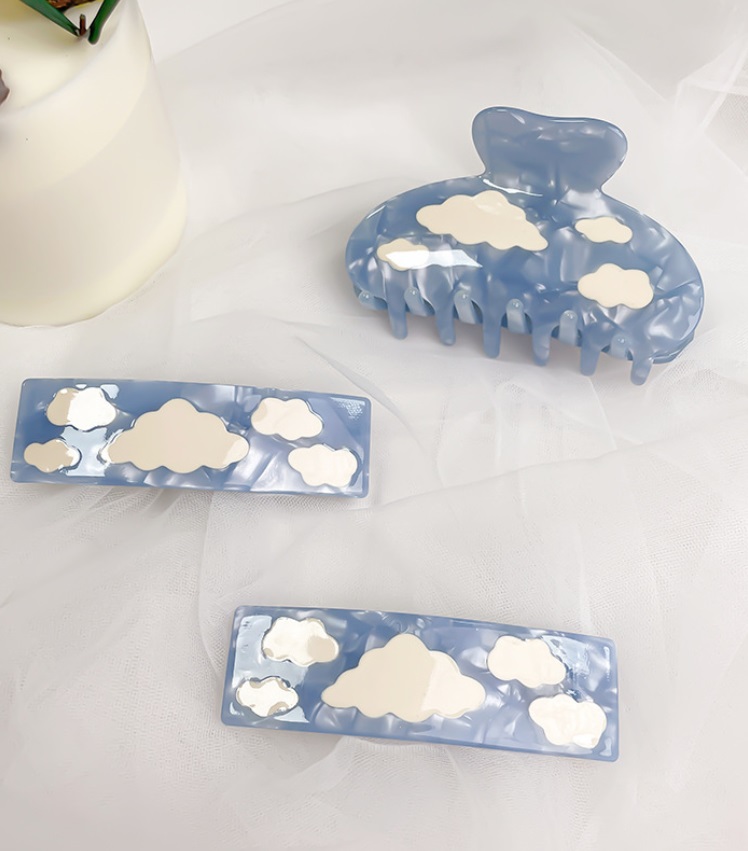 A detailed look at the blue cloud pattern on the acetate hair clip