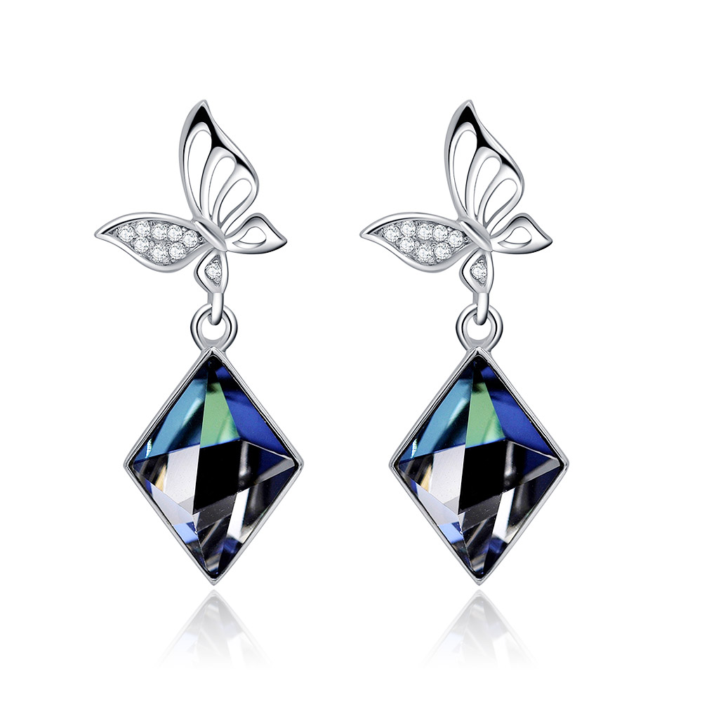 A detailed view of the 925 sterling silver earrings showcasing the blue gemstones and flower-shaped tops.