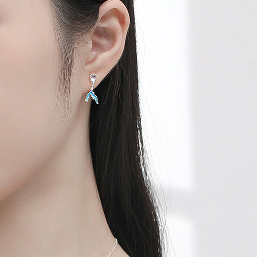 Model showcasing the sterling silver mermaid tail earrings