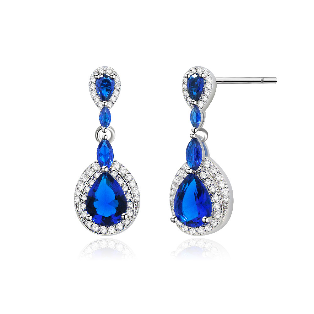 A detailed side view of the Tear Drop Pear Cubic Dangle Earrings showcasing the sapphire and cubic zirconia stones.