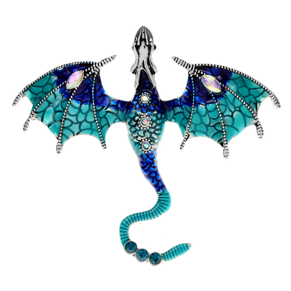 Blue and teal enamel dragon brooch displayed on a neutral surface