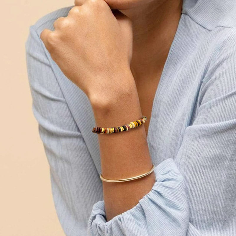 A detailed showcase of two distinct bohemian-style beaded bracelets with gold accents.