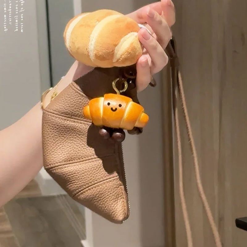 PU bread charms attached to a brown leather purse