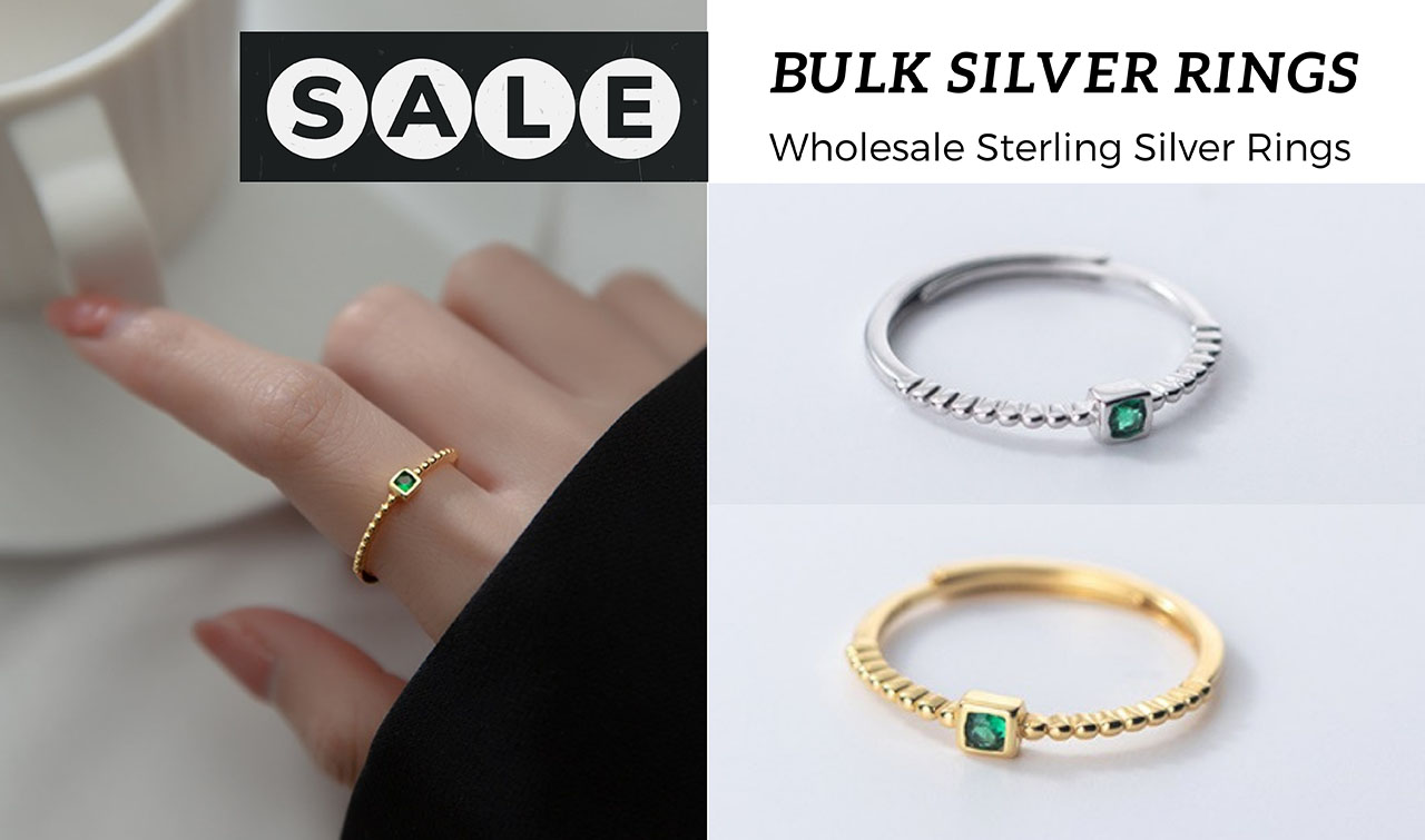 A collection of wholesale sterling silver rings with green gemstones in both gold and silver finishes.