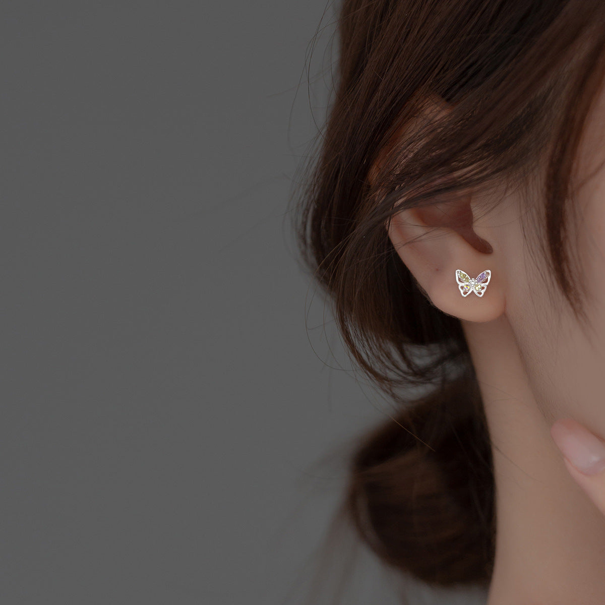 Model showcasing the 925 sterling silver butterfly stud earring