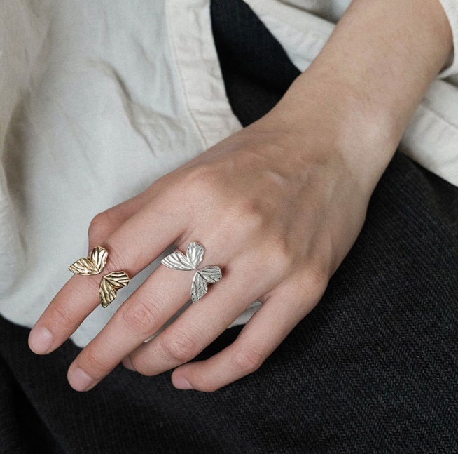 A pair of 925 sterling silver butterfly rings showcasing the intricate design details.