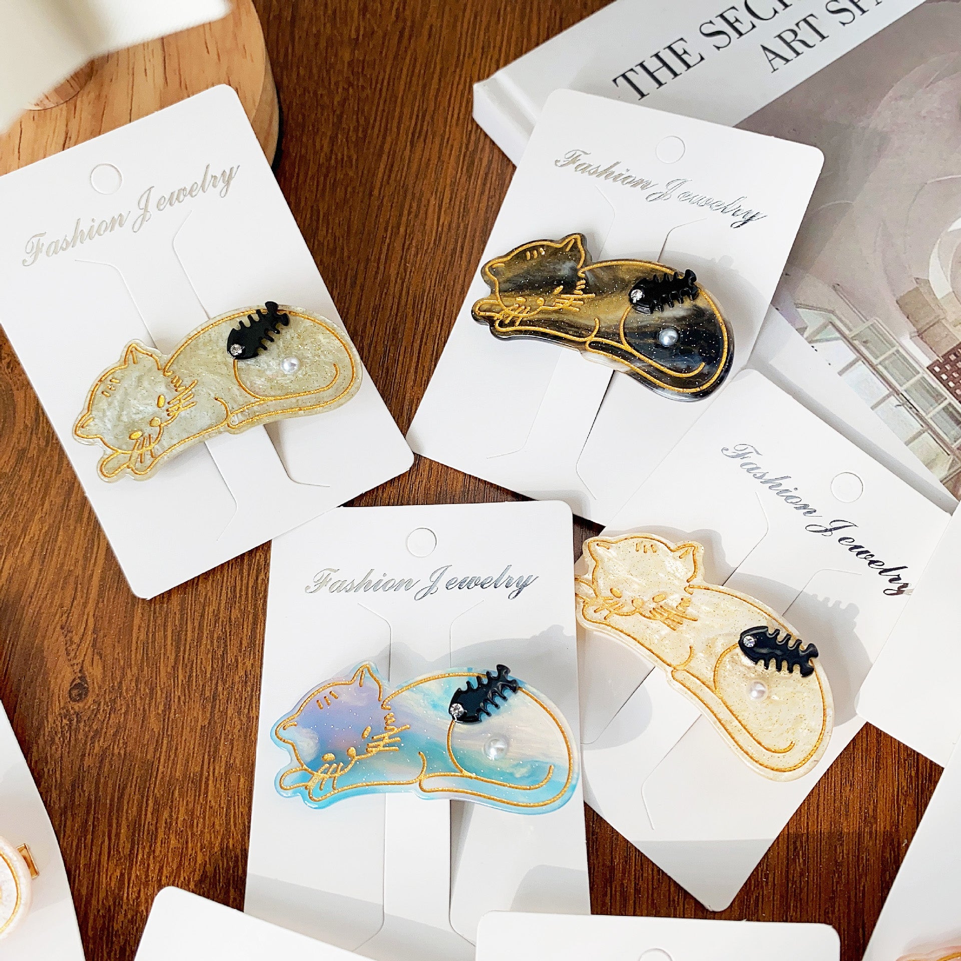 A trio of cat-themed acetate hair clips in different colors