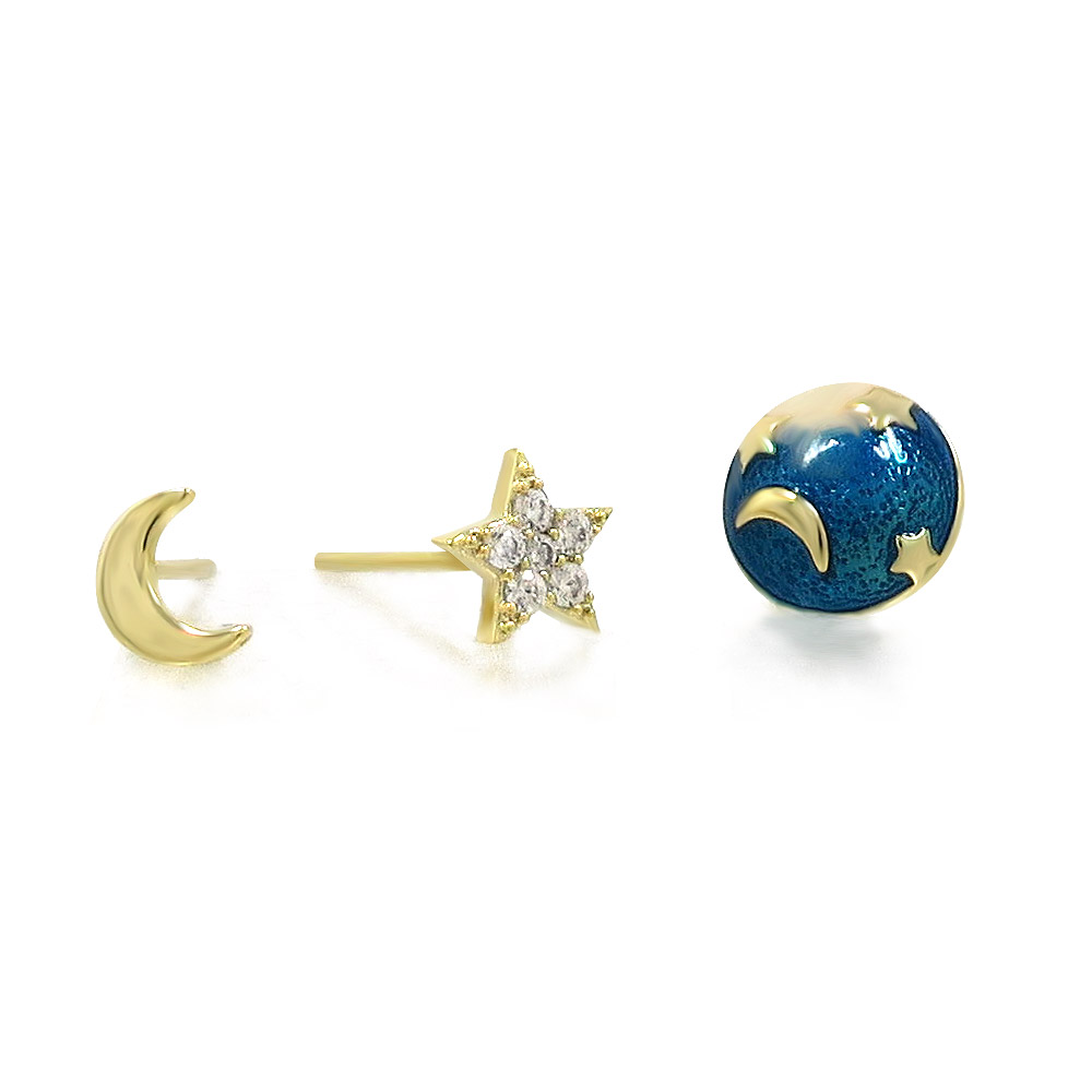 Detailed view of the celestial-themed gold earrings: moon, star, and planet.