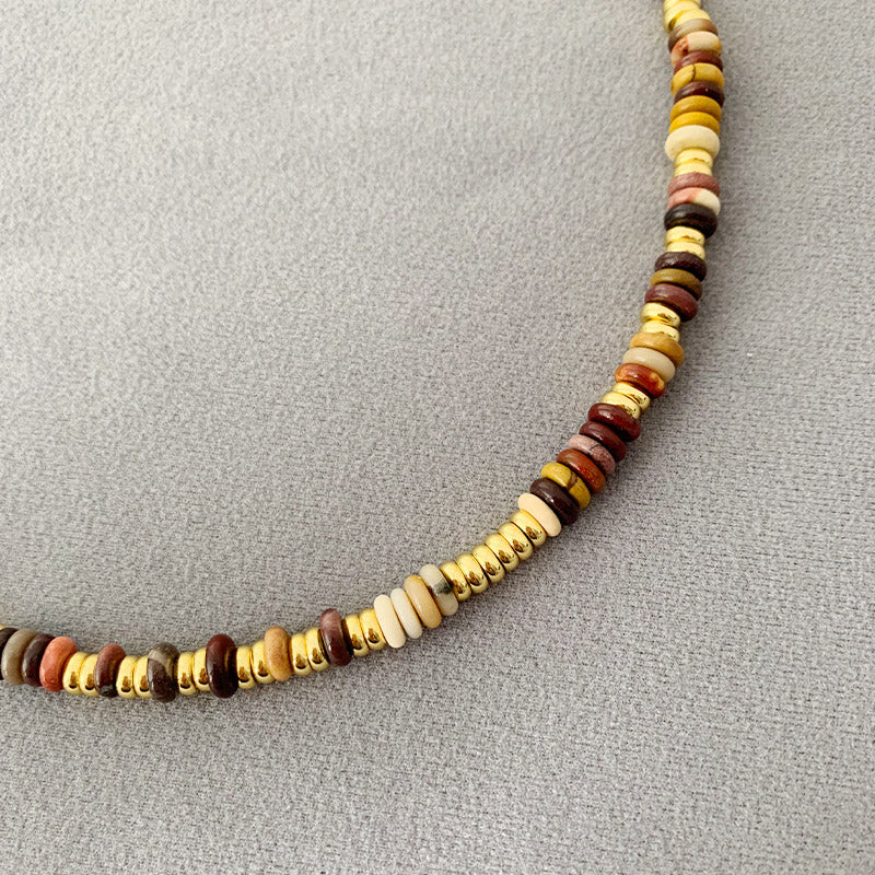 Detailed close-up of the natural beads and brass components of the boho necklace