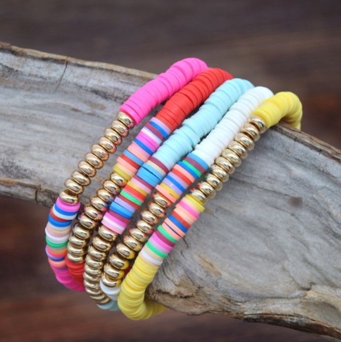 Detailed view of the colorful polymer clay and gold bead bracelets