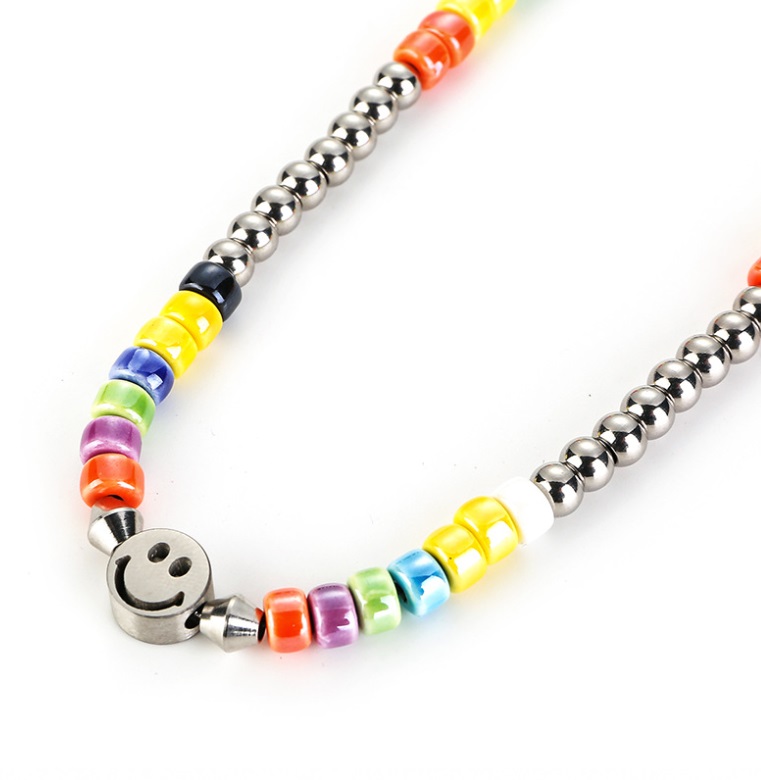 Detailed view of the rainbow beaded necklace with a smiley charm