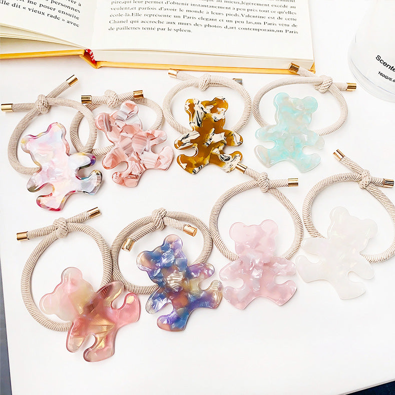 A vibrant collection of bear-shaped charms for hair ties in multiple colors.