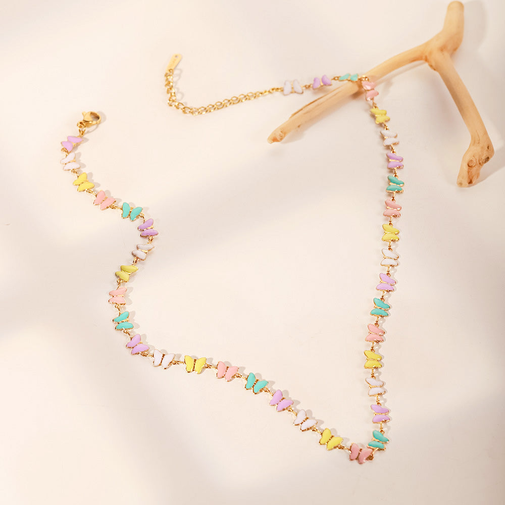Detailed shot of the gold chain and colorful butterfly charms