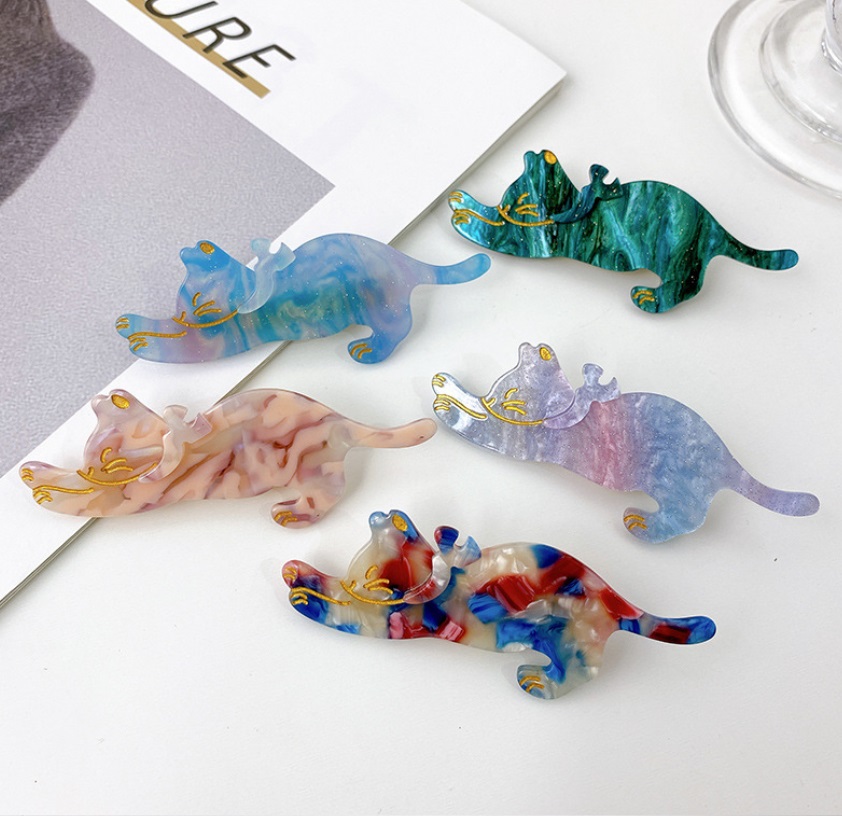 A vibrant collection of five wholesale acetate hair clips, each shaped like a cat with unique marbled patterns and elegant gold accents.