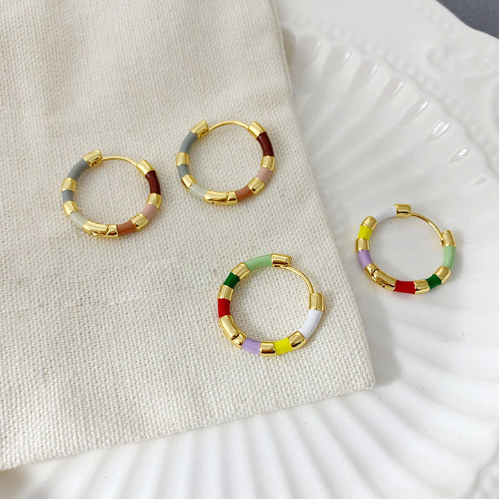 A collection of colorful gold hoop earrings available for wholesale