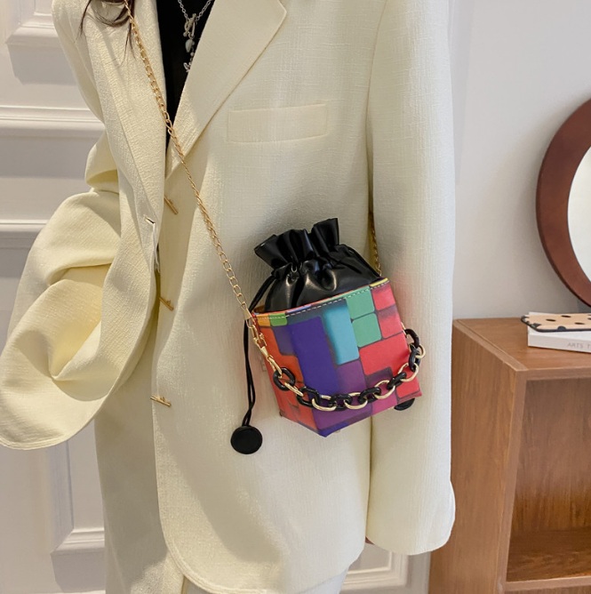 A model showcasing the Rainbow Square Crossbody Chain Bag with a fashionable outfit