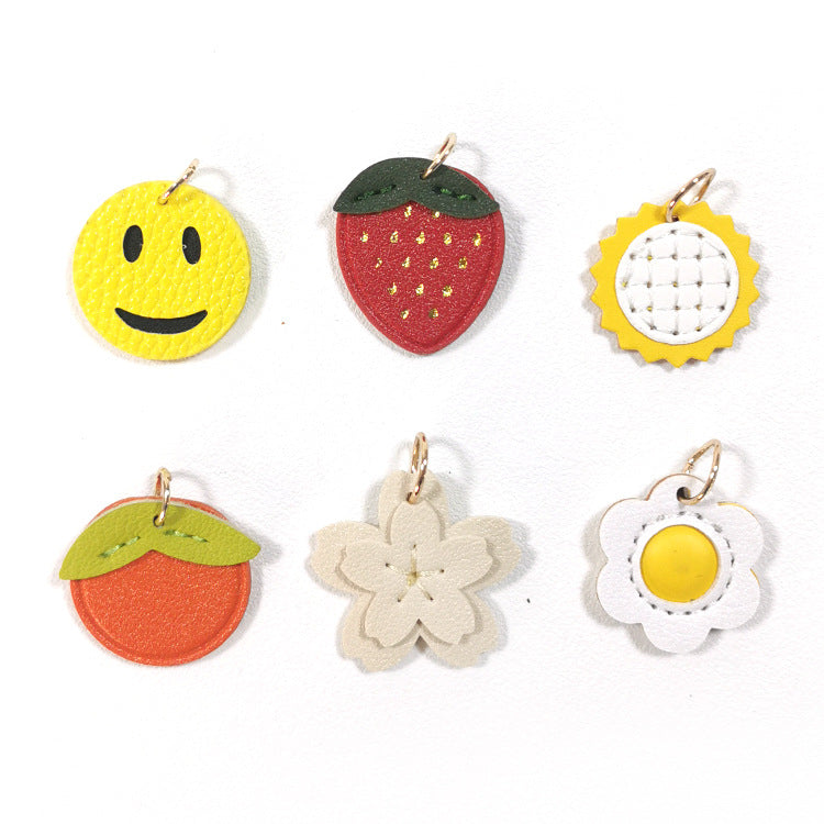 A variety of colorful PU leather charms including a smiley face, strawberry, and flowers.