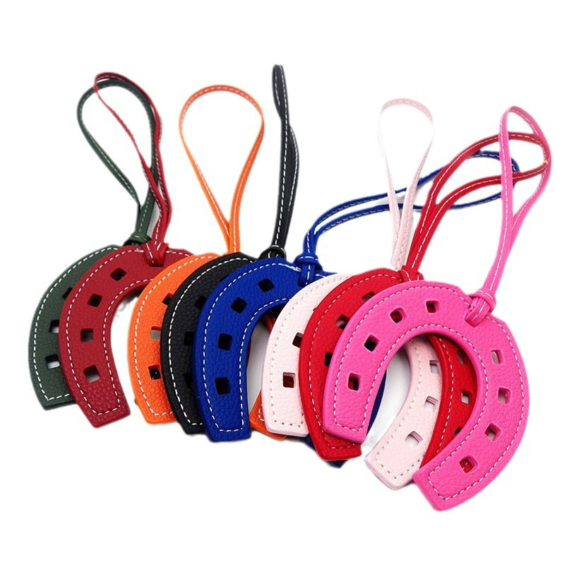 A vibrant collection of PU leather horseshoe keychains in multiple colors.