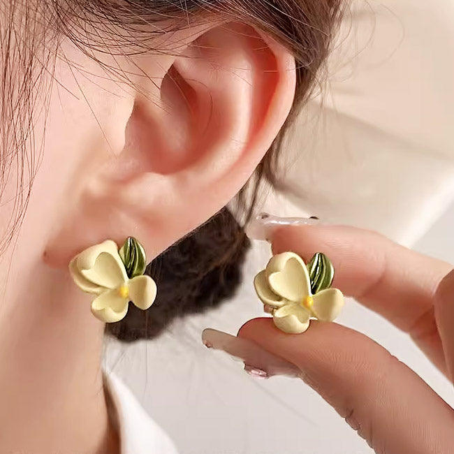 Model showcasing the vibrant yellow gardenia flower stud earrings