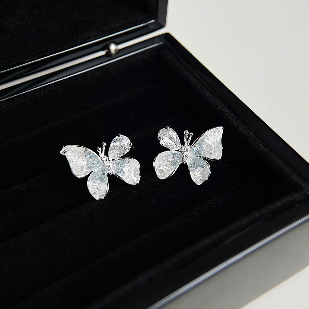 The set of crystal butterfly earrings displayed in a box