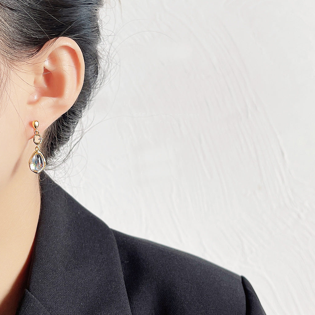 Model wearing the 14k gold plated clear glass water drop earrings