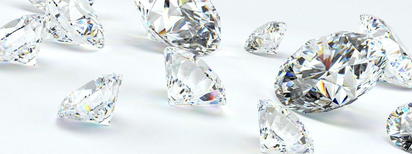 A brilliant collection of sparkling diamonds on a white background, representing the April birthstone.
