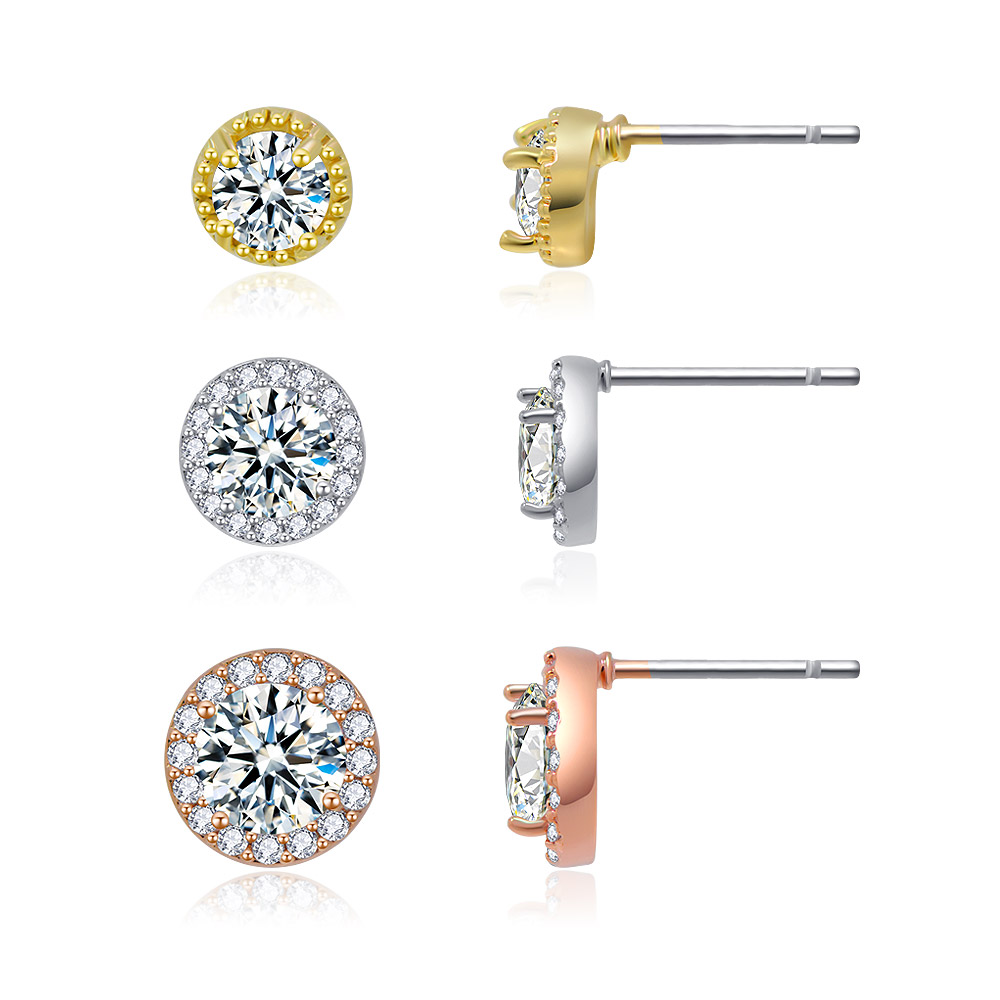 Detailed view of the three pairs of tri-tone stud earrings