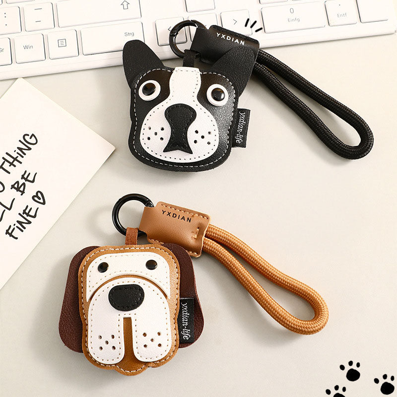A close-up of the black and brown dog-themed leather keychains
