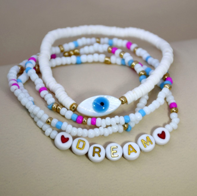 Detailed view of the DREAM and evil eye bracelets