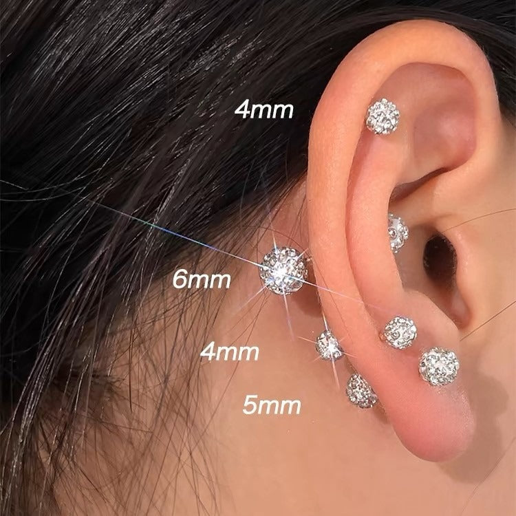 A diagram showing different sizes of crystal ball earrings on an ear for styling reference.