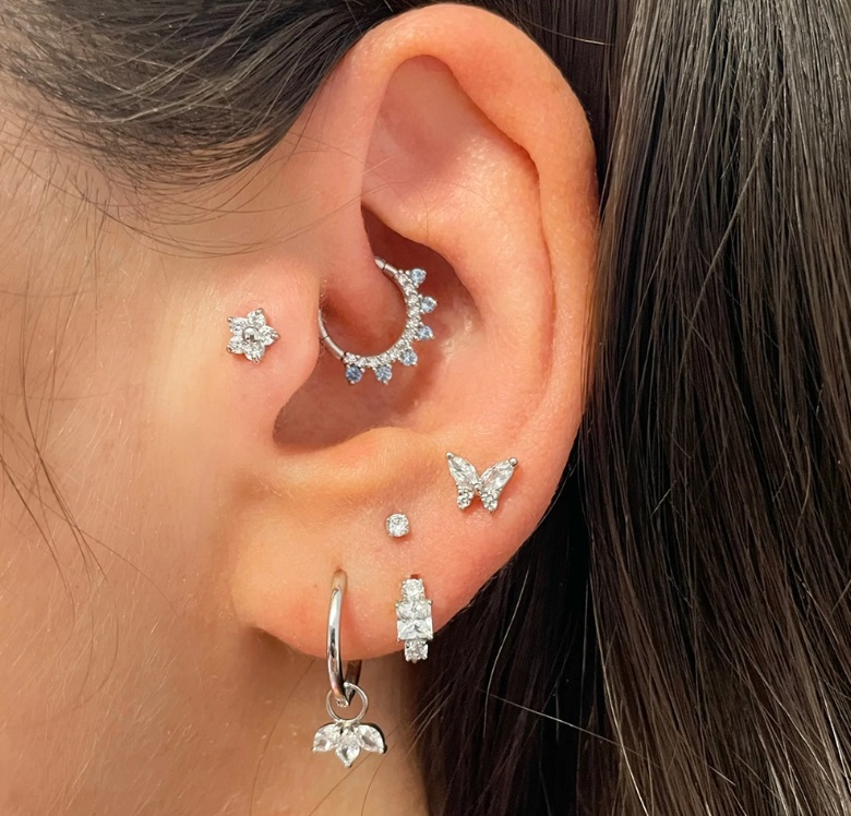 A model showcasing the versatile styling of the 925 Sterling Silver Huggie Earrings.
