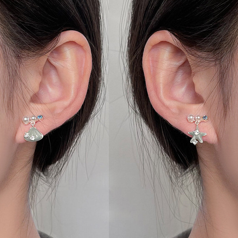 Detailed view of the silver-plated starfish and teardrop stone earrings