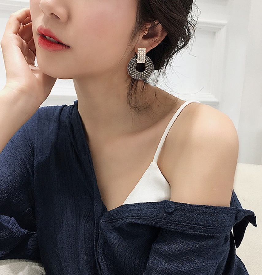 Model wearing the black and clear crystal statement earrings