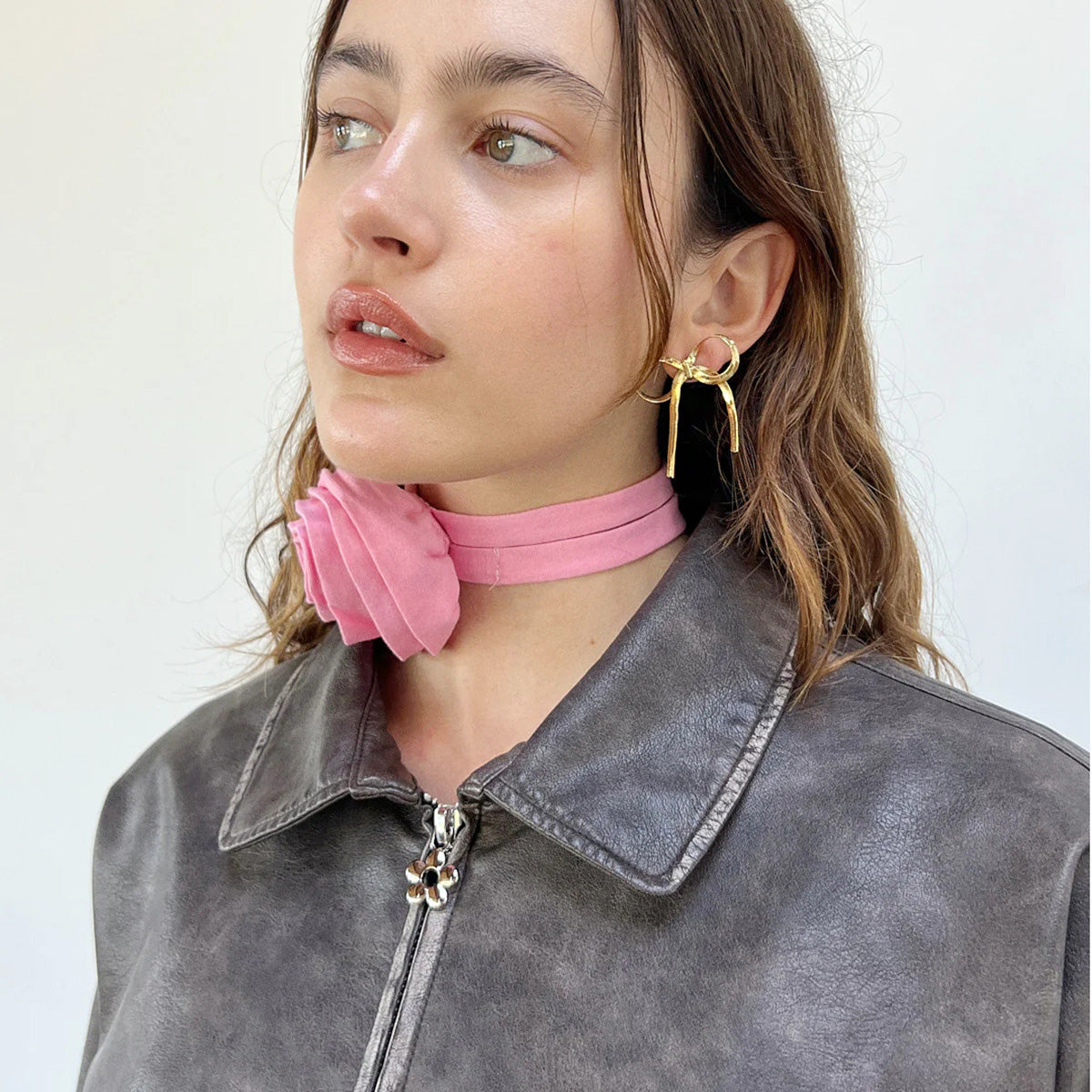 Model showcasing the stylish stainless steel bow earrings