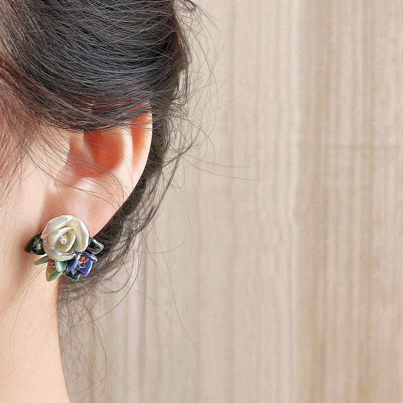 A model wearing the 3D white ceramic flower stud earring