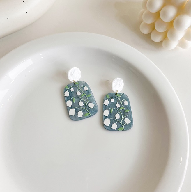 Detailed view of the intricate floral pattern on the resin earrings