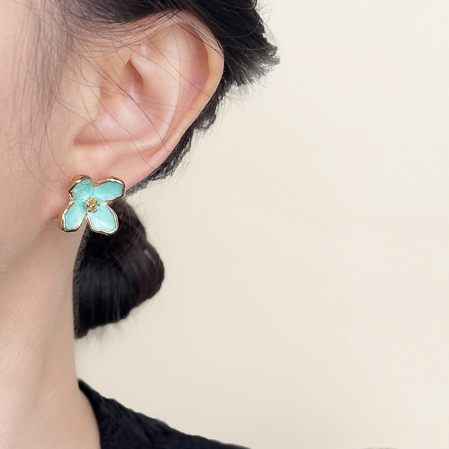 Model wearing the mint green flower stud earring