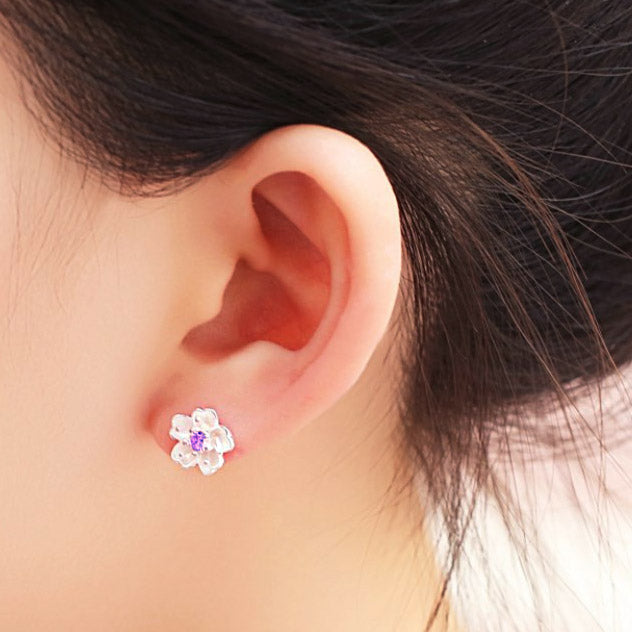 A model showcasing the 925 Sterling Silver Cherry Blossom Earring for scale.