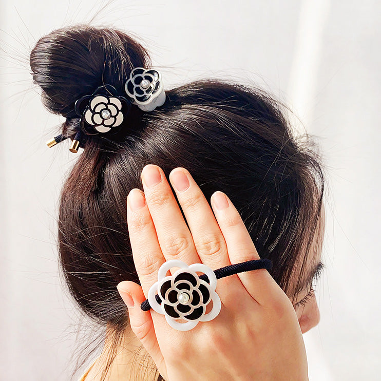 A set of black and white camellia flower hair accessories