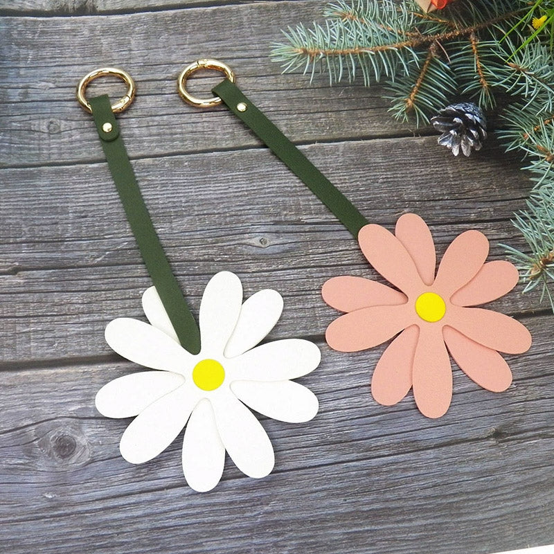 White and pink daisy flower bag charms side-by-side