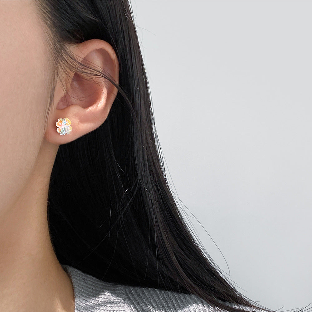 Model showcasing the delicate fit of the four-leaf clover stud earring