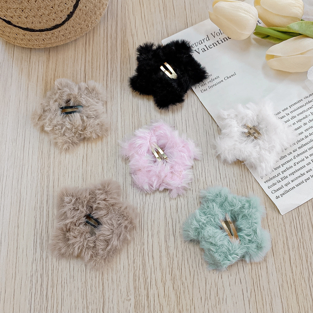 A vibrant collection of plush star hair clips in multiple colors.
