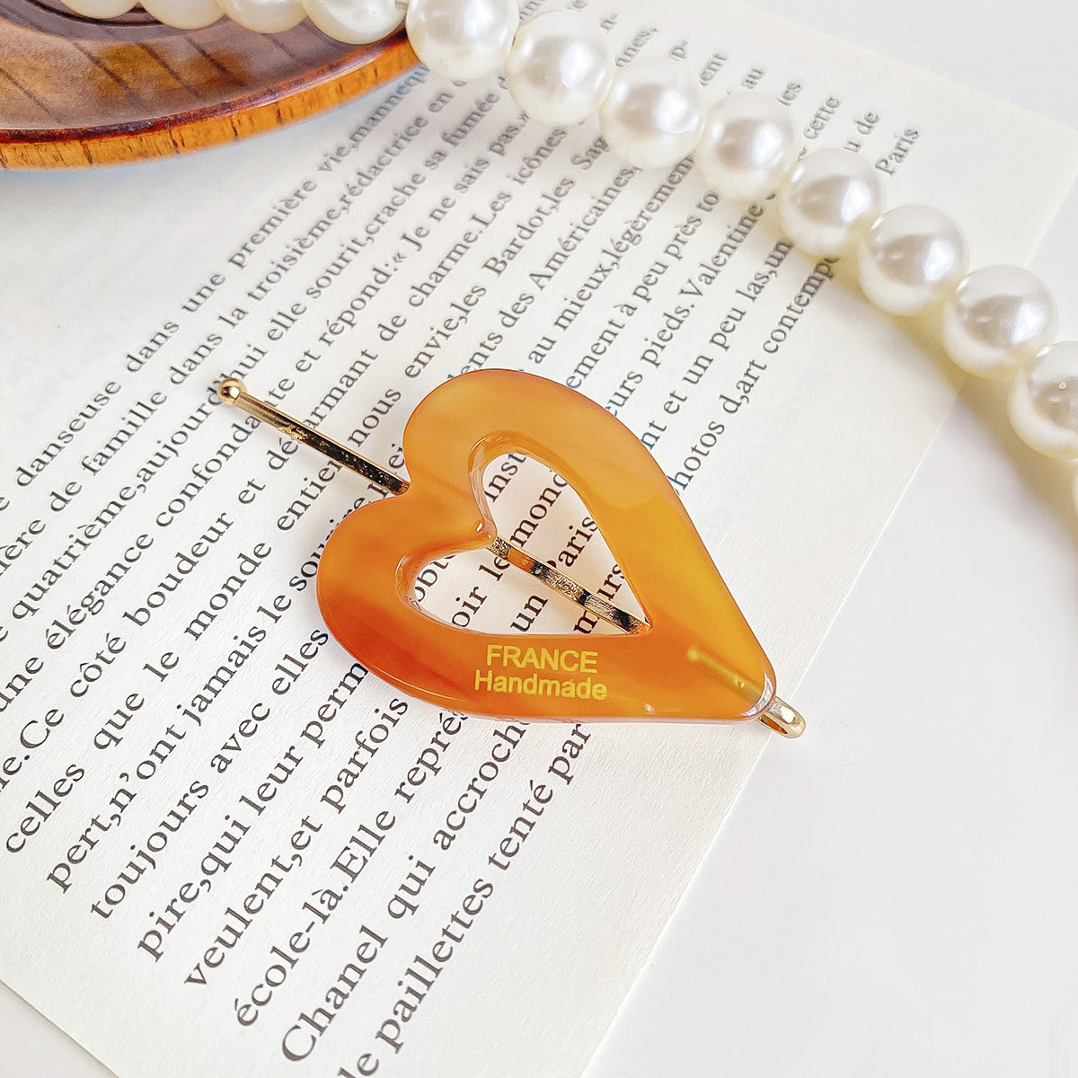A stylish tortoiseshell patterned heart-shaped hair clip